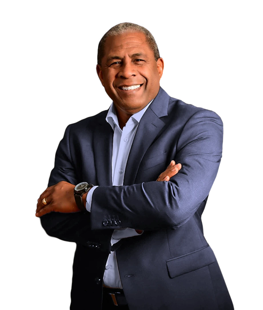 Kenneth Corbie, executive coach, smiling with arms crossed